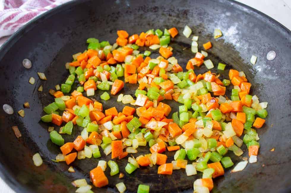 Sauteed veggies in a large pan.