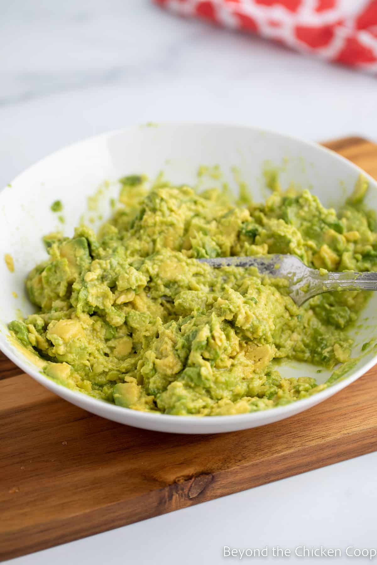 Mashing avocados with a fork. 