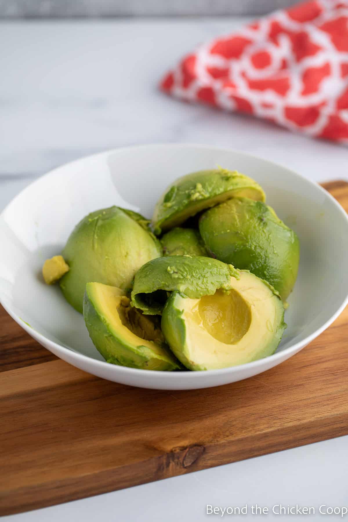 Halved avocados in a bowl. 