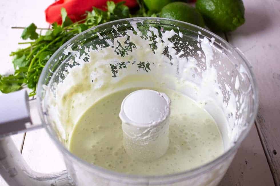 A food processor bowl filled with Greed yogurt.