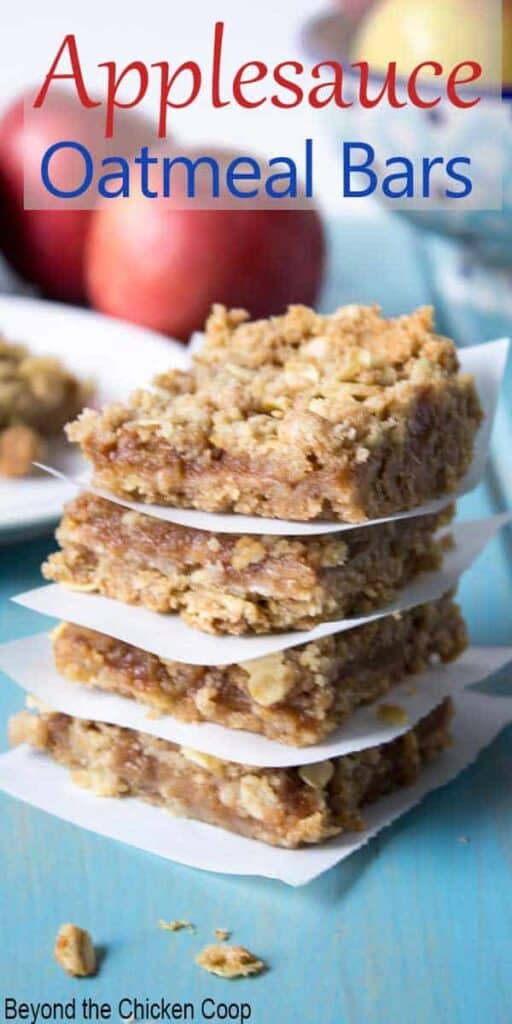 Four oat bars stacked with a piece of parchment paper between each bar.