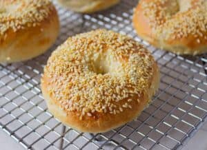 A bagel topped with toasted sesame seeds.