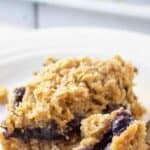 Oatmeal bar with a blueberry filling on a white plate.