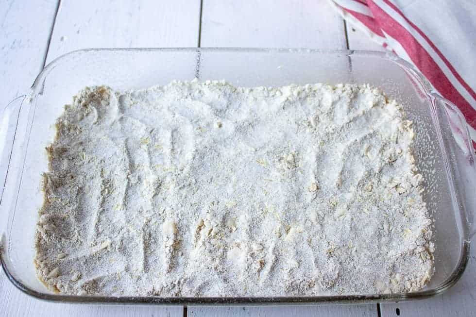 Oat crust pressed into a glass casserole dish.