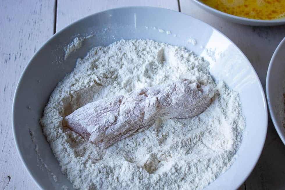 Chicken breast dredged in flour.