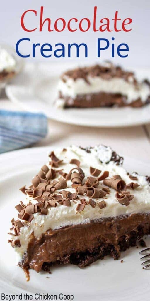 A slice of chocolate cream pie topped with whipped cream and chocolate shavings.
