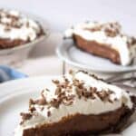 A slice of chocolate pie topped with whipped cream.