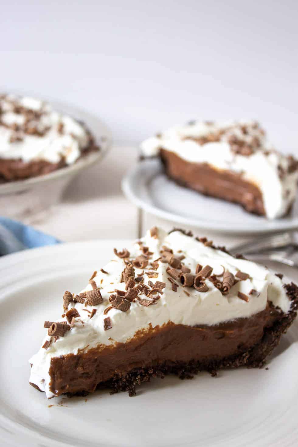 A slice of chocolate pie topped with whipped cream. 