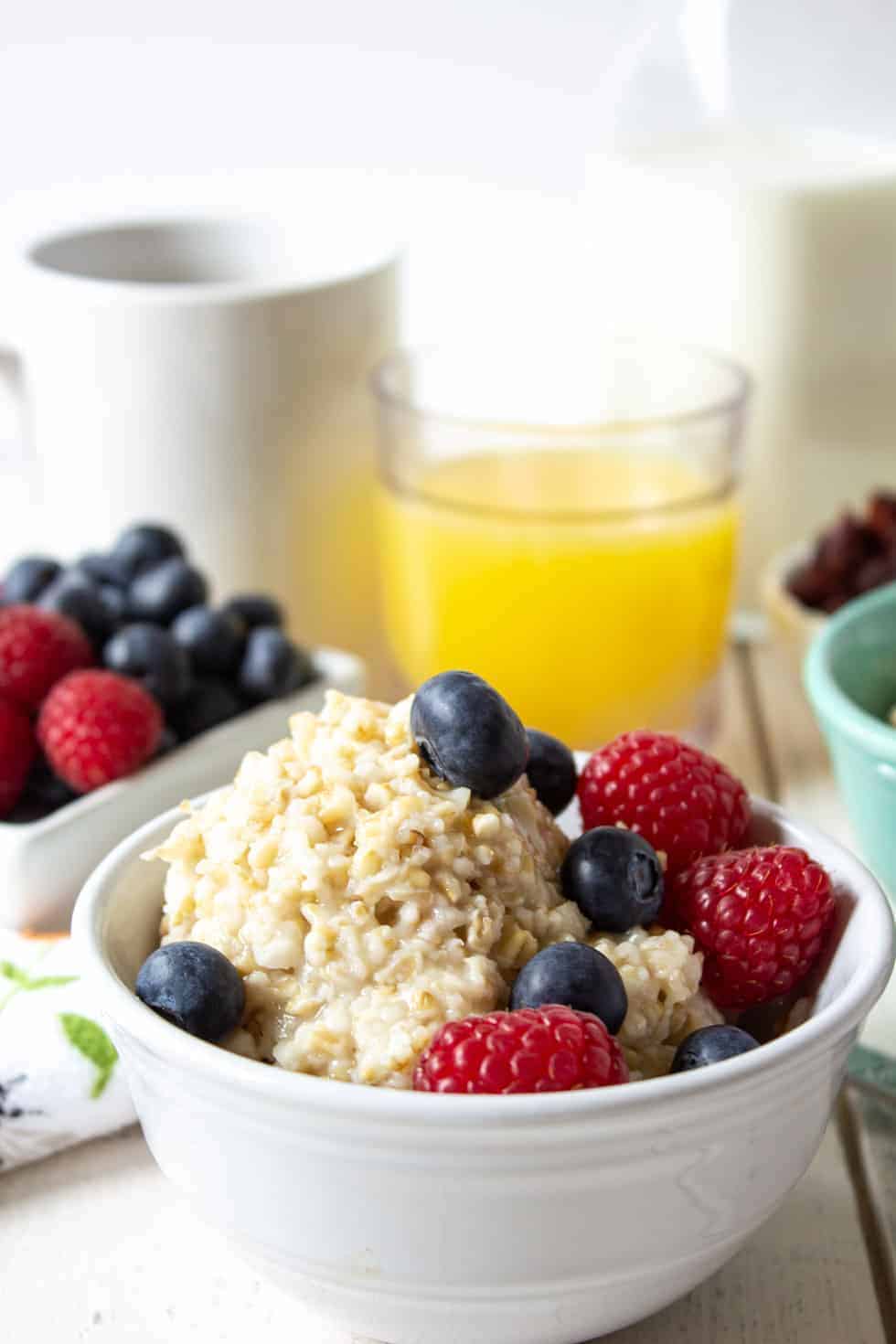 Steel Cut oats in a bowl topped with fresh berries. 