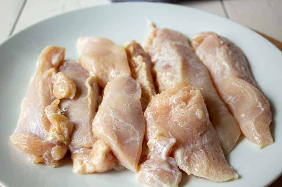 Chicken breasts cut into thin strips.