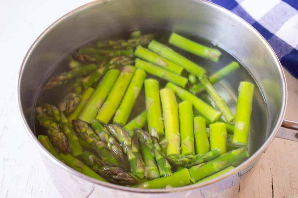 Cut asparagus in a pot of hot water.