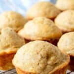 Muffins resting on a baking rack.