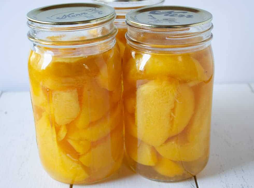 Quart jars filled with peaches.