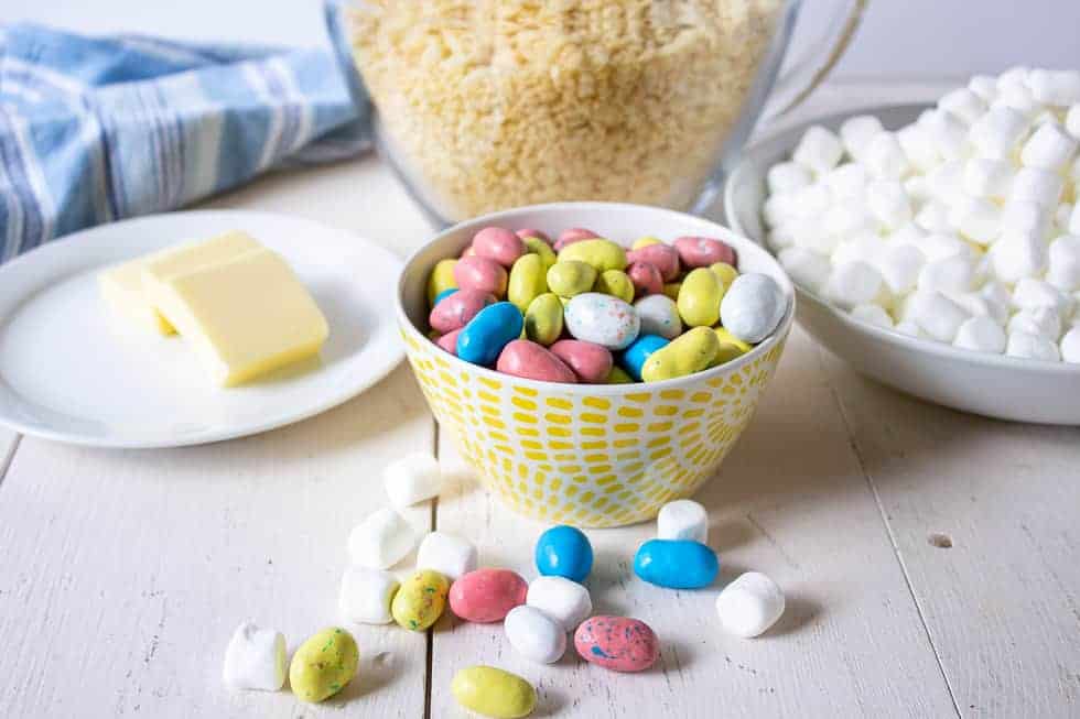 Mini malted eggs, butter, rice krispies and marshmallows all displayed on a white board.