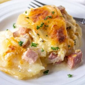 Sliced potatoes with chunks of ham in a creamy casserole.