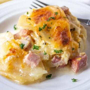 Sliced potatoes with chunks of ham in a creamy casserole.