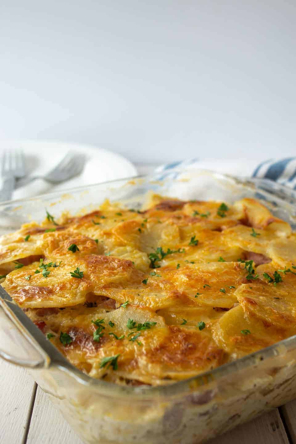 A casserole topped with browned cheese and fresh chopped chives.