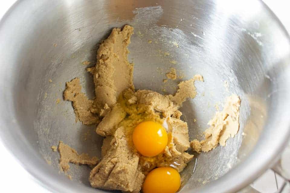2 Eggs in a bowl with a mixed cookie batter.