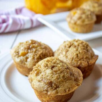 Three muffins with peaches.