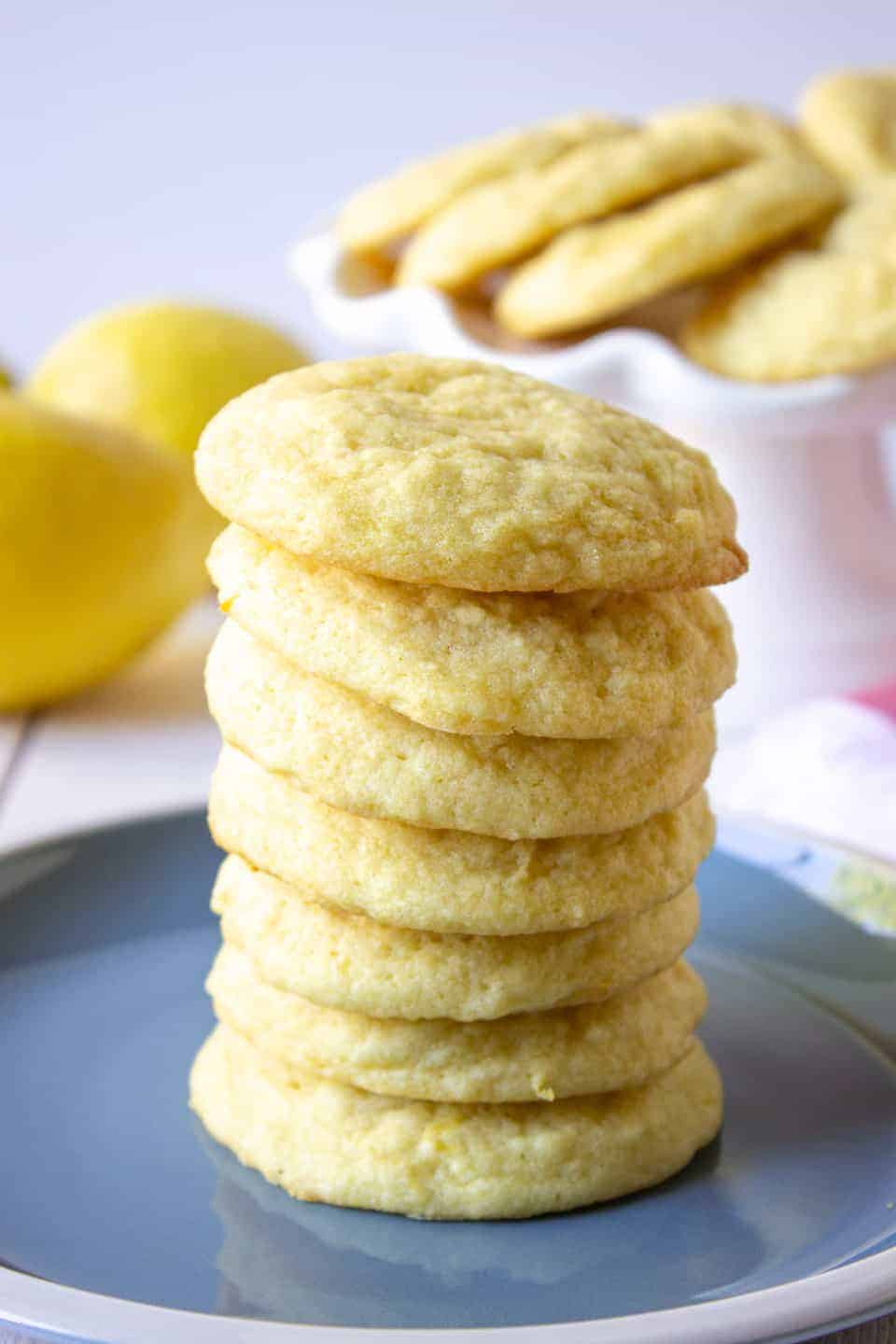 A tall stack of sugar cookies on a blue plate. 