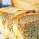 Sliced bread overlapping in a line on a plate.