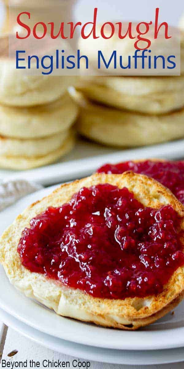 Toasted muffin on a plate covered with raspberry jam.