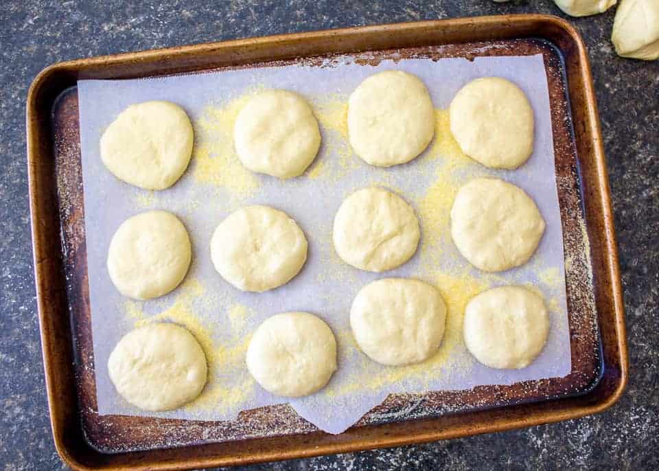 Round pieces of dough on a baking sheet.