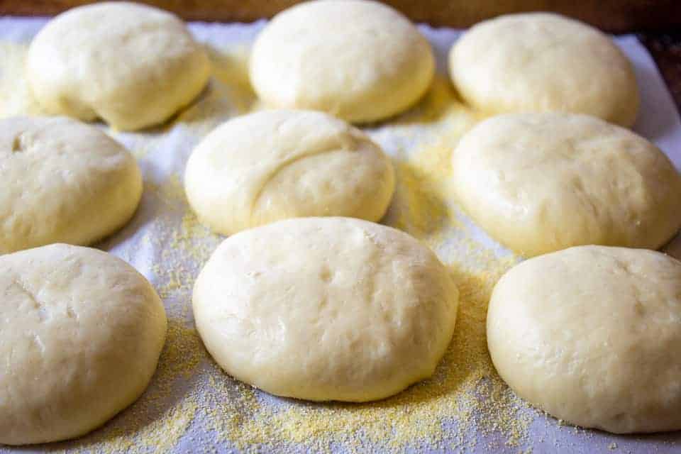 Round rolls of dough on a baking sheet.