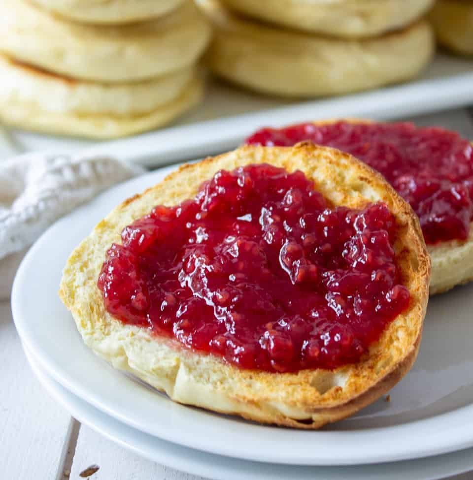 Toasted English muffin slathered with raspberry jam. 