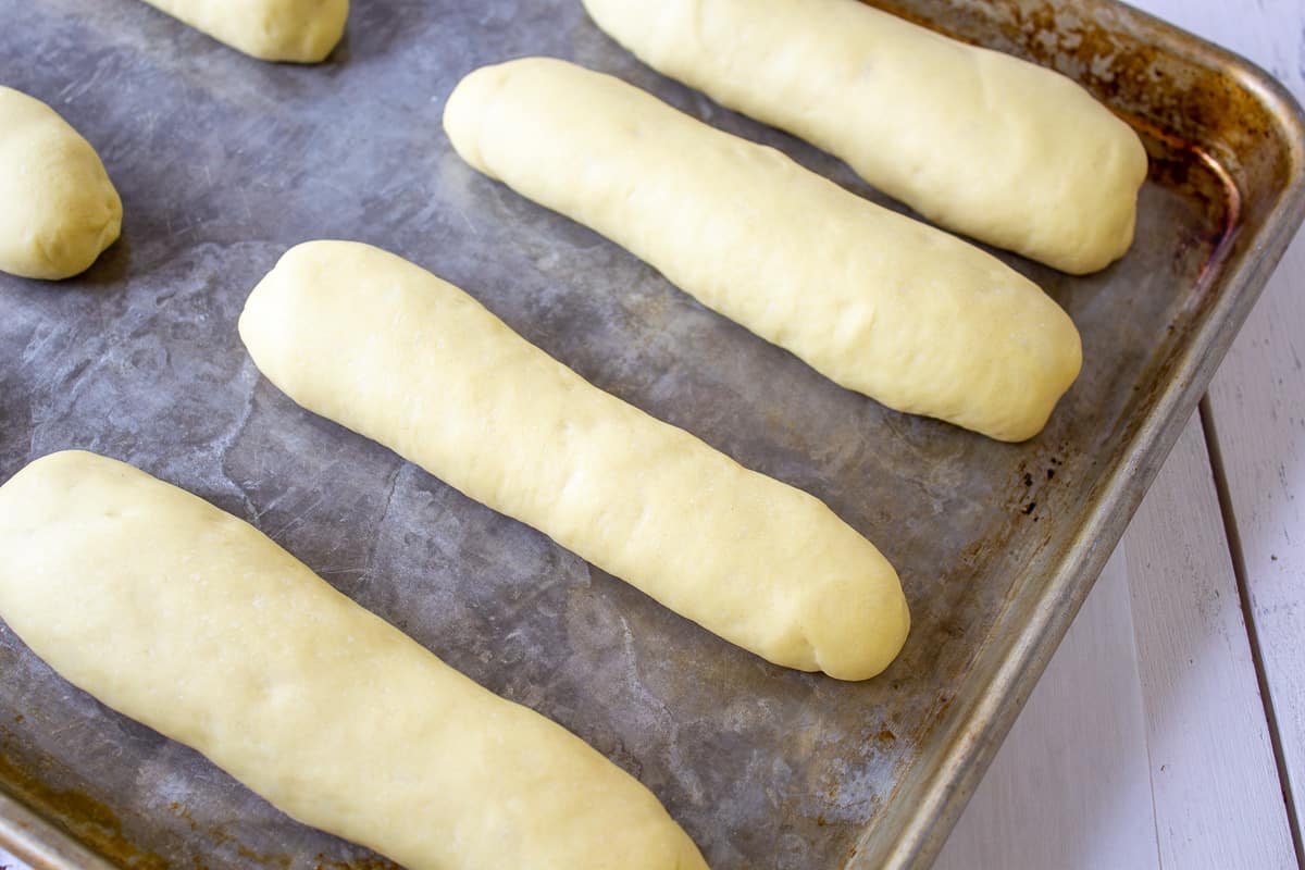 Shaped bread dough in long rolls.