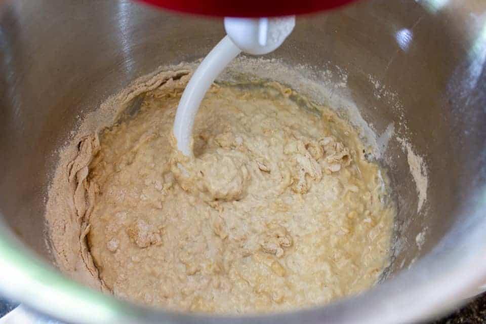 Bread dough being mixed in a mixing bowl.