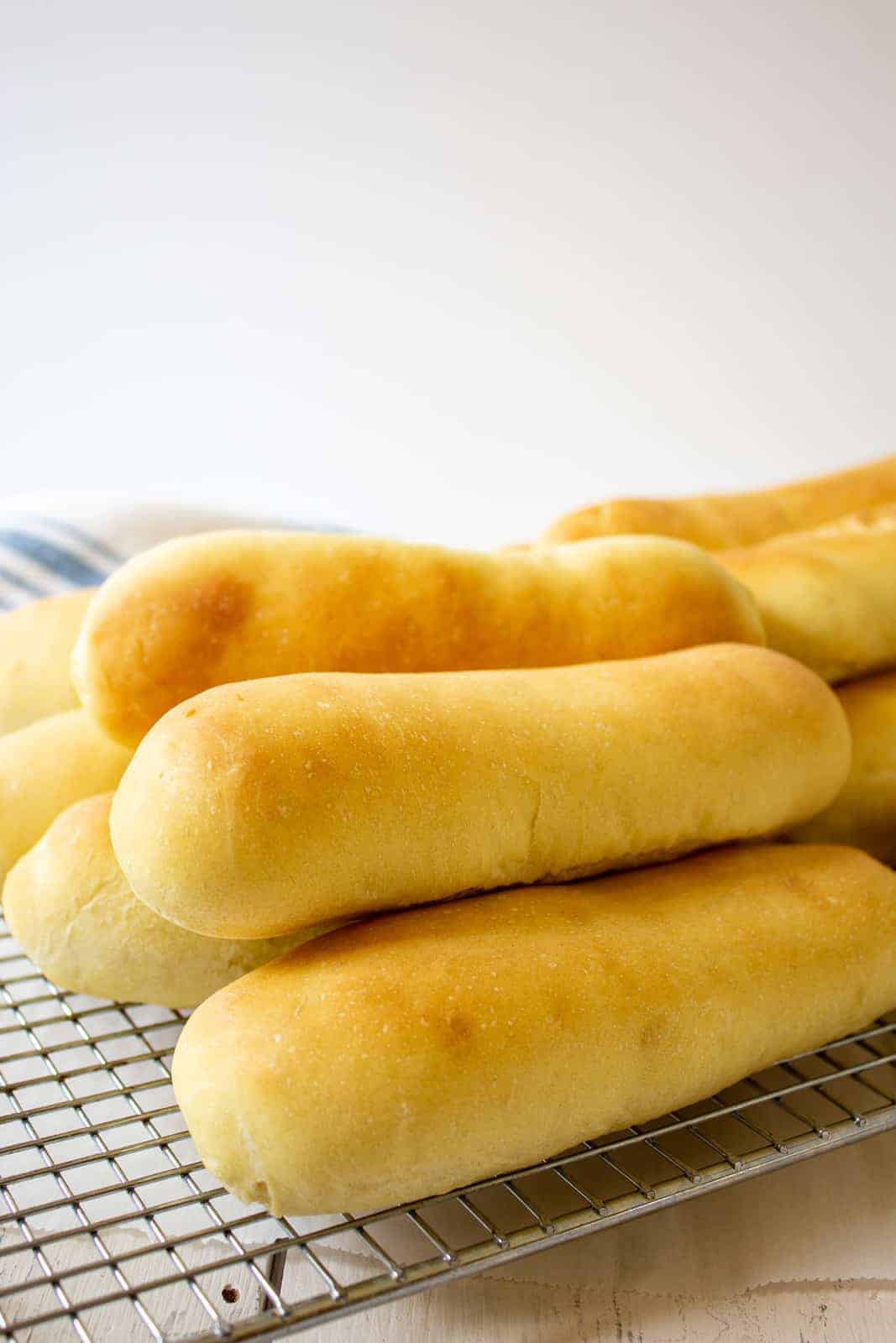 Hot Dog rolls on a baking rack. 
