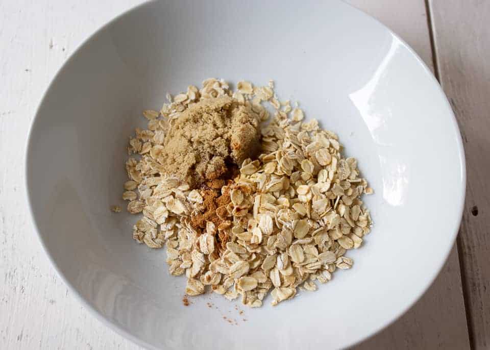 Oatmeal with brown sugar and cinnamon in a white bowl.