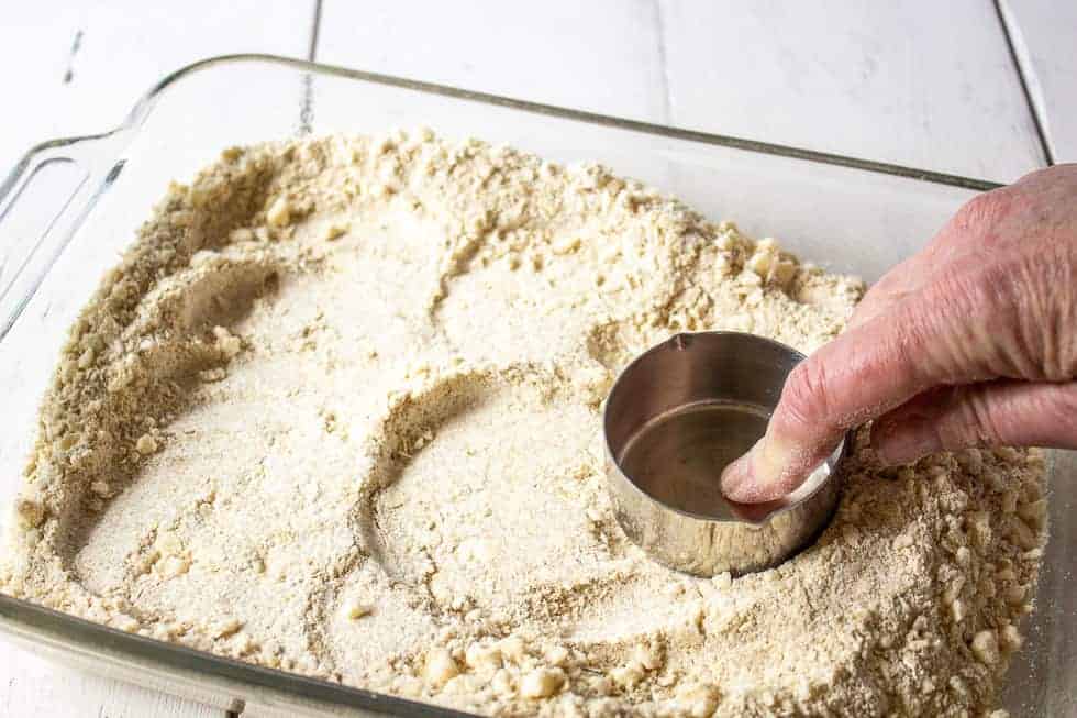 Crust being formed into a glass baking dish.