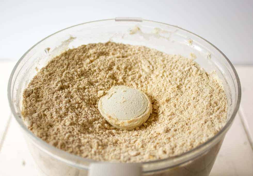 Flour and oat mixture in a food processor bowl.