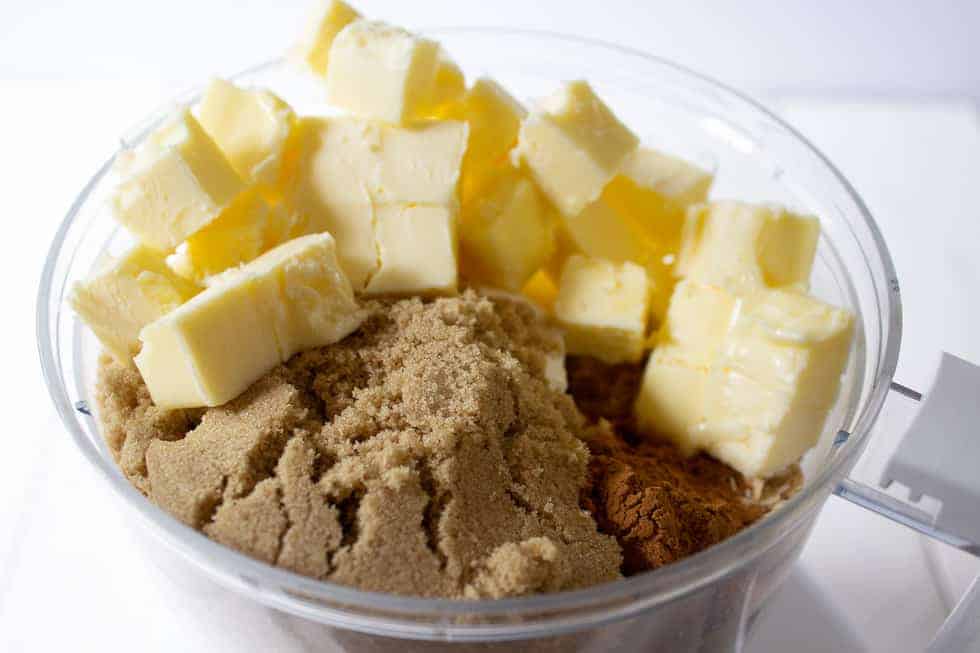 A food processor filled with butter and brown sugar.