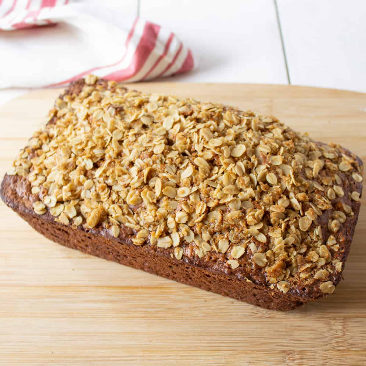 A loaf of banana bread topped with oats.