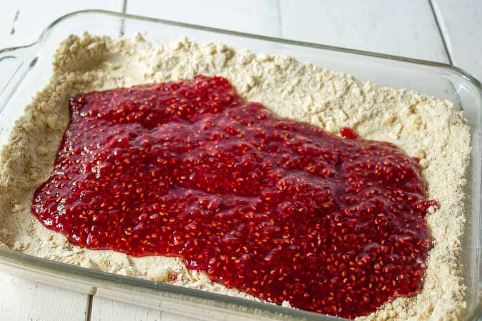 Raspberry jam spread over a flour and oat crust.