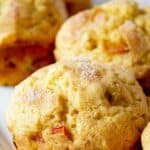 Rhubarb muffins lined up on a white platter.