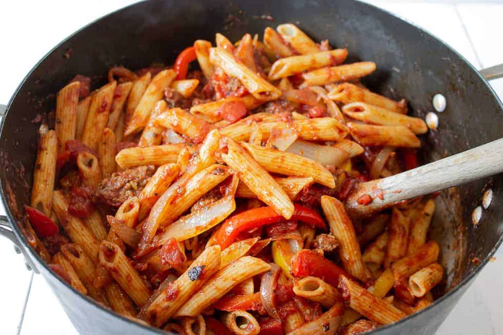 A large pot filled with pasta and a tomato sauce.