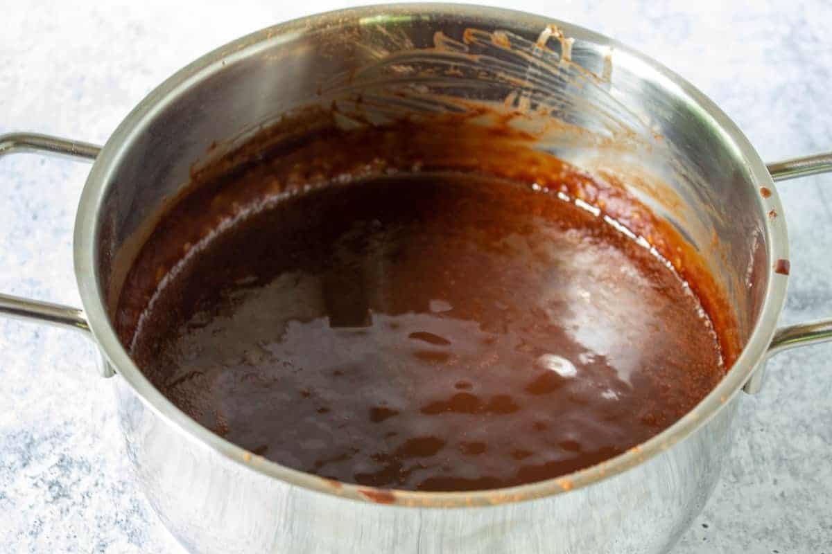 Hot fudge sauce bubbling in a pot.