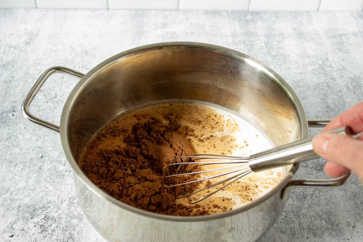 A pot filled with cream and cocoa powder.