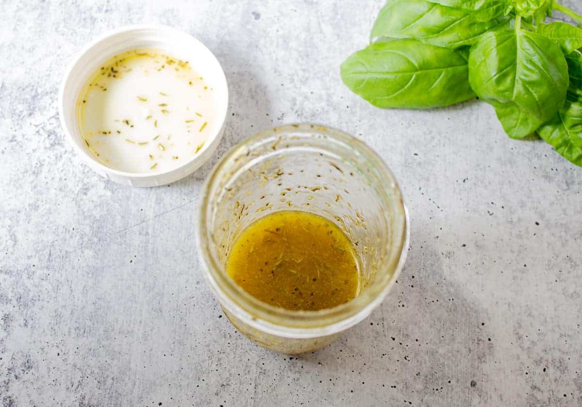 Salad dressing in a glass canning jar with a white lid. 