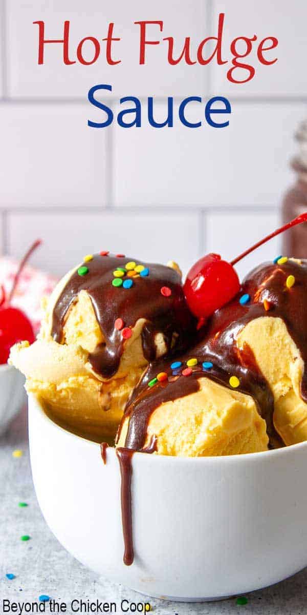 Hot fudge sauce dripping over scoops of vanilla ice cream.
