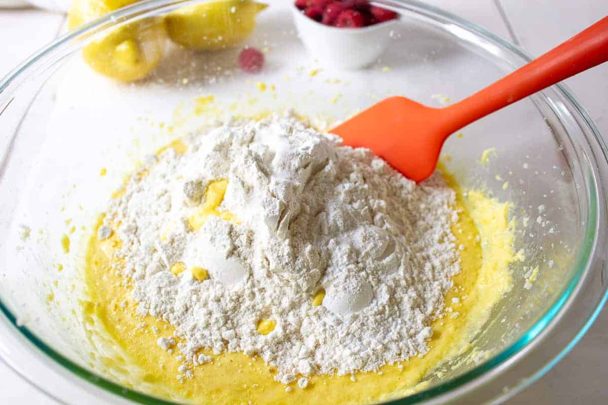 Flour being added to muffin batter.