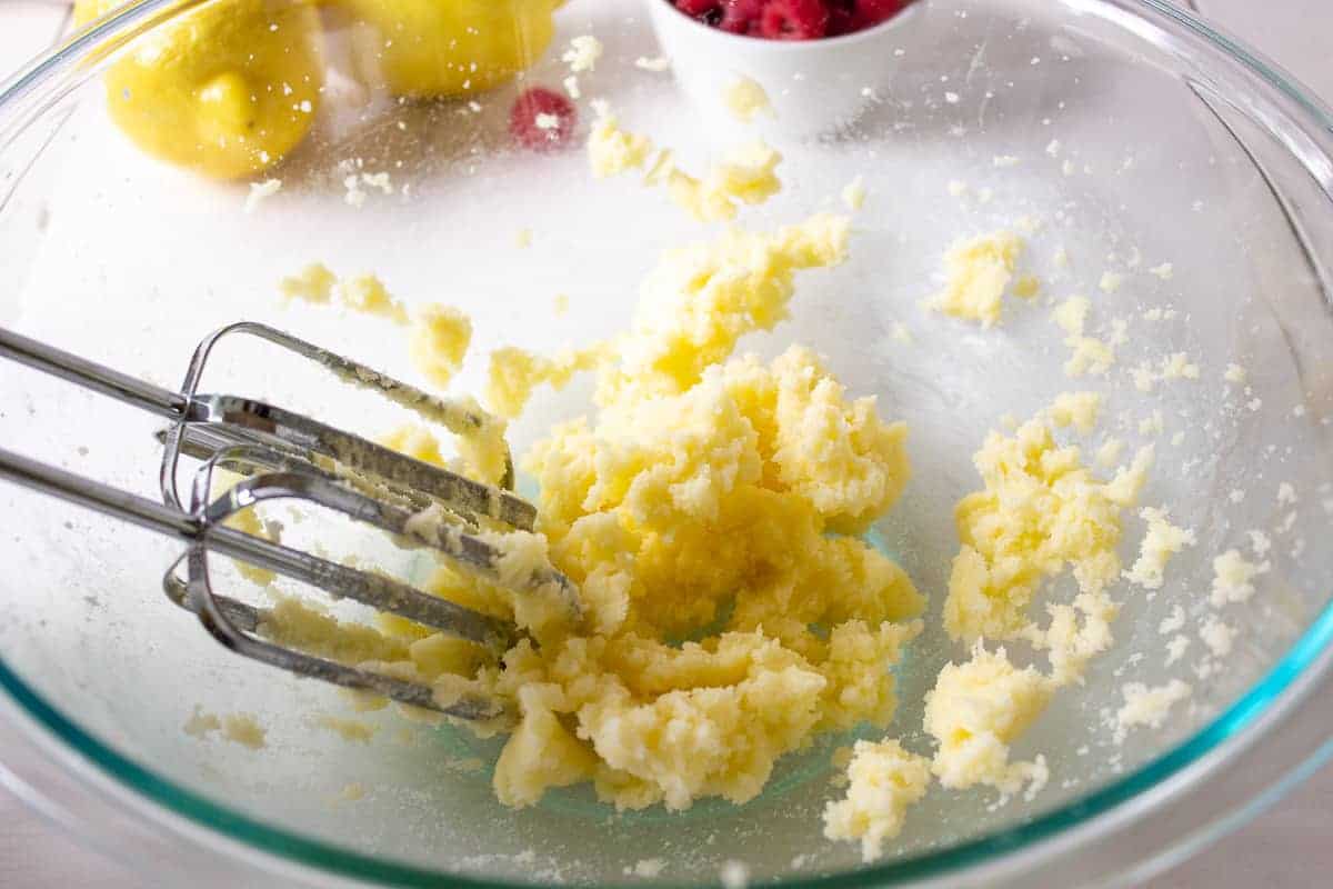 A glass bowl with whipped butter and sugar.