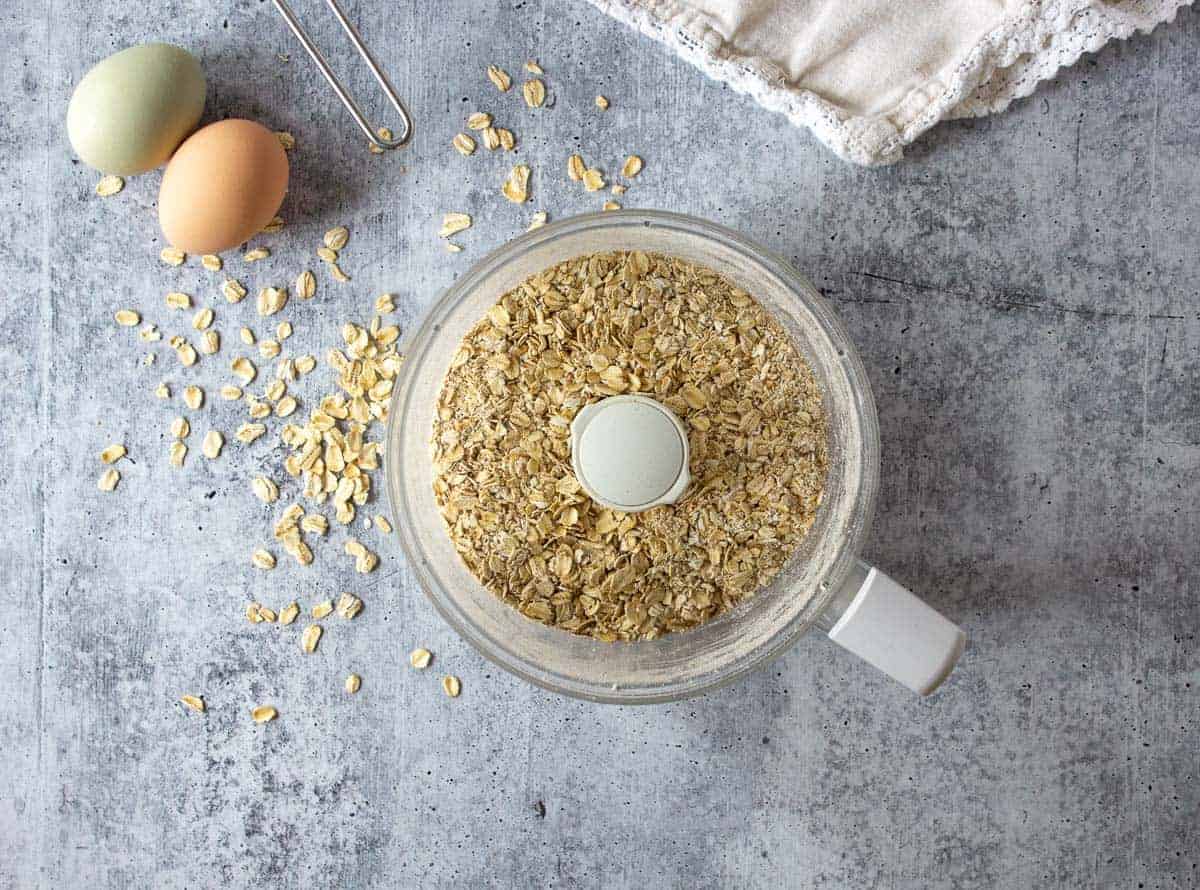 A food processor bowl filled with oats.