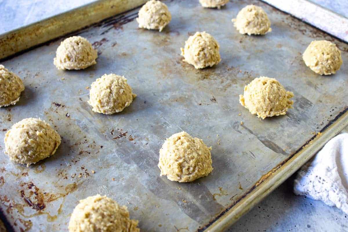 Scoops of cookie dough on a baking sheet.