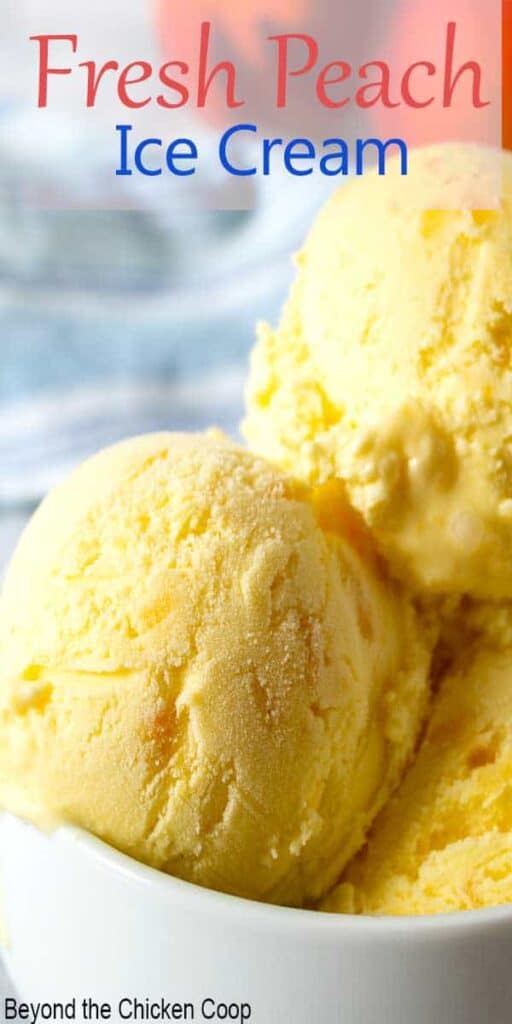 Scoops of peach ice cream in a white bowl.