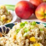 Quinoa salad with peaches and brown rice in a bowl.